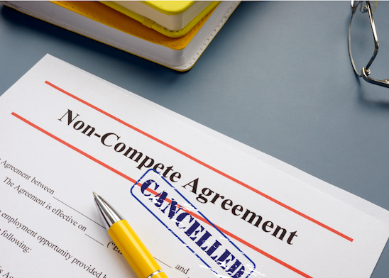 Non-Compete Agreement paperwork with yellow pen