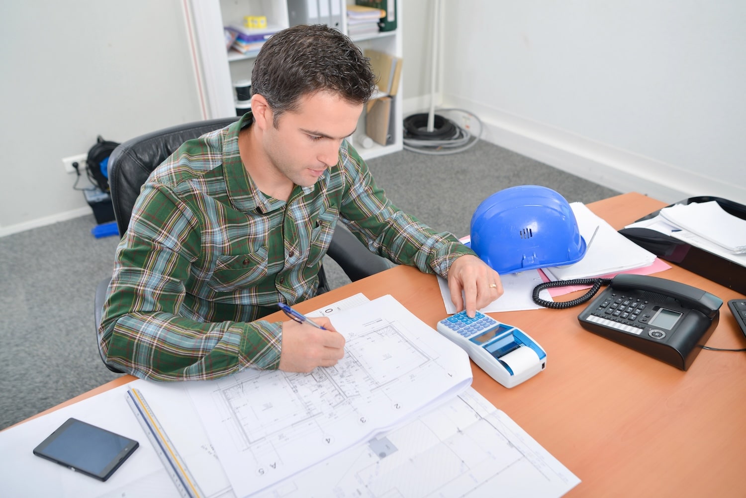 Construction manager looking at books