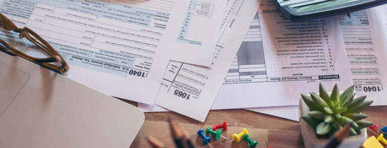 Business owner reviewing New York sales tax documents and calculating penalty savings