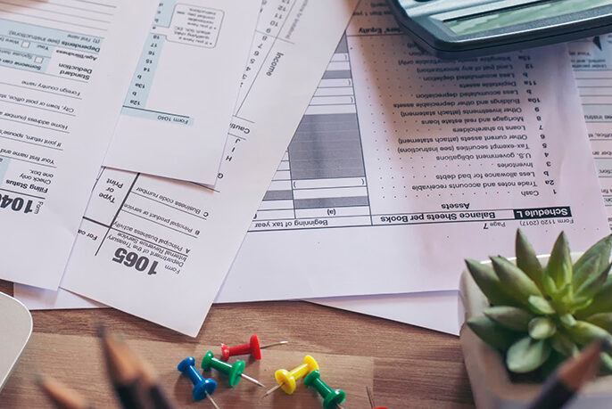 Business owner reviewing New York sales tax documents and calculating penalty savings